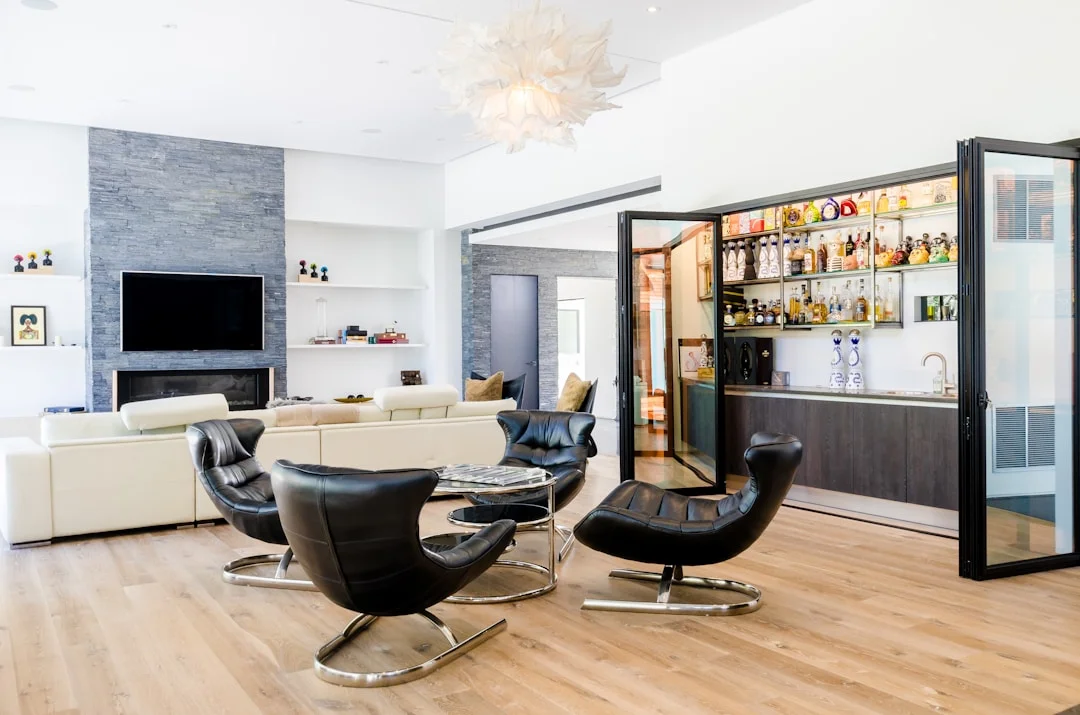 Modern finished basement with hidden bar and elegant lounge area