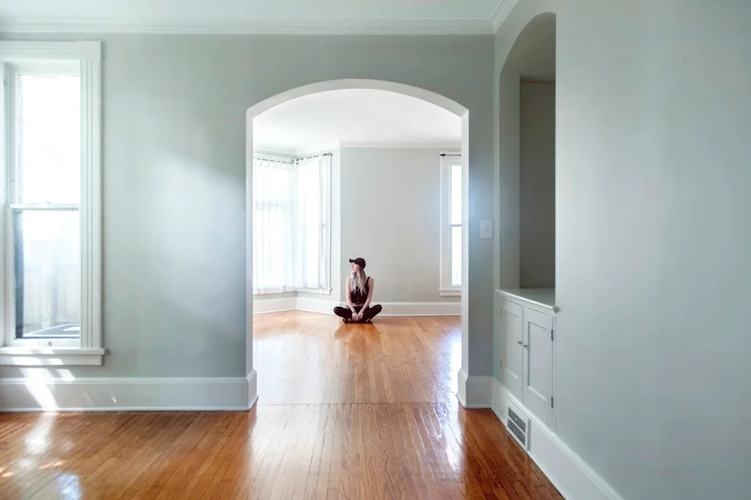 Bright heritage interior with classic arched doorway and original hardwood floors bathed in natural light