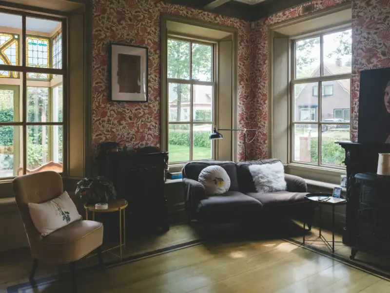 Heritage home interior with original hardwood floors and tall windows filled with natural light
