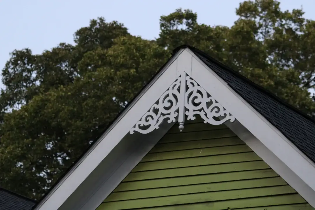 Decorative carved wood ornament at the gable apex of a heritage house