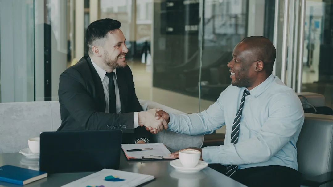 Deux professionnels qui se serrent la main après la signature d'un contrat de rénovation