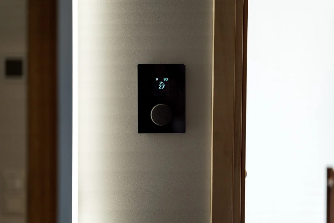 Thermostat mural moderne noir sur mur blanc