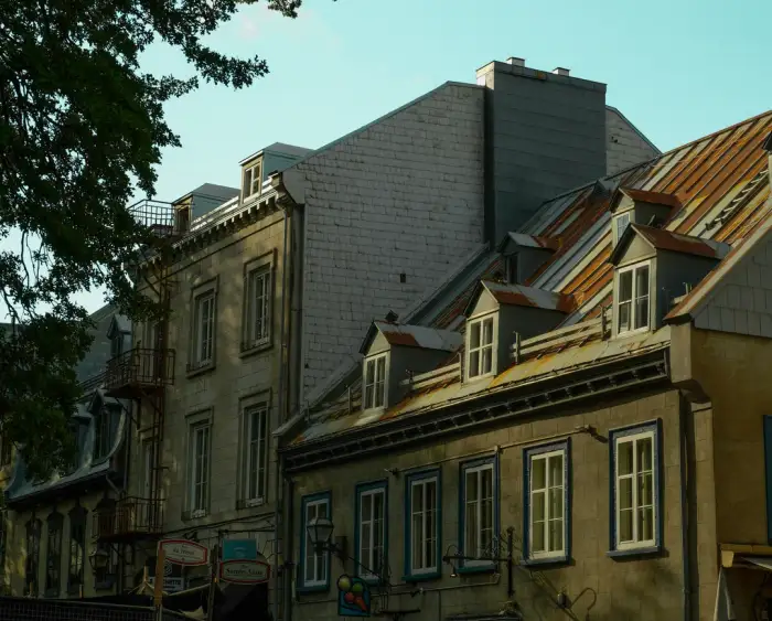 Heritage rooftops and dormers in the streets of Old Quebec, slate and metal roofing