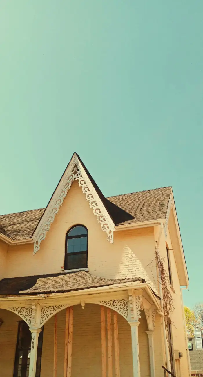 Ornate dormer windows on an old stone heritage building, architectural detail