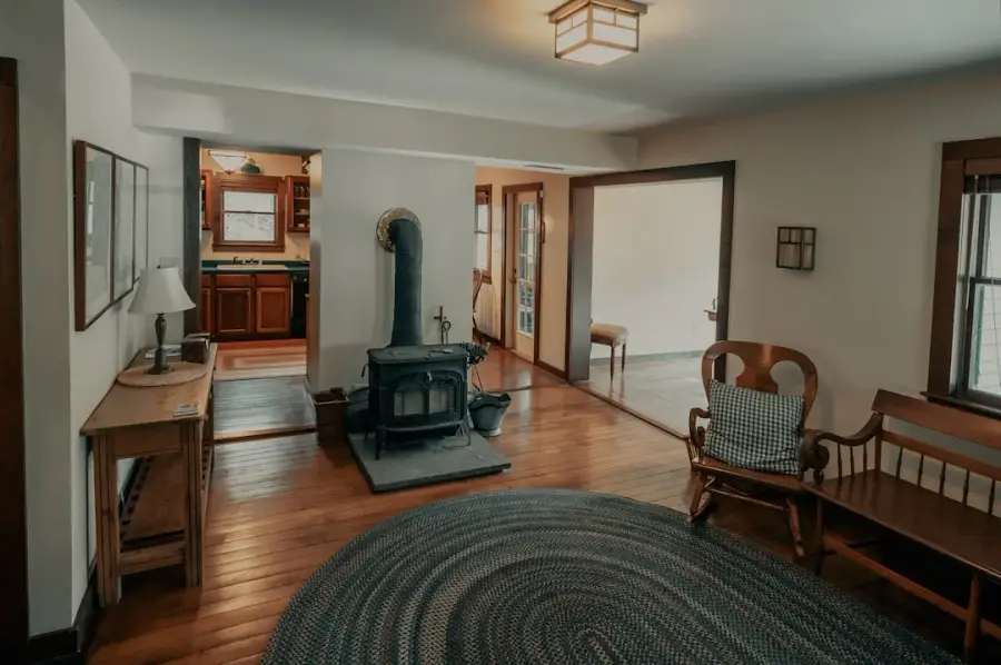 Warm interior of an old country home with wood stove and original hardwood floors